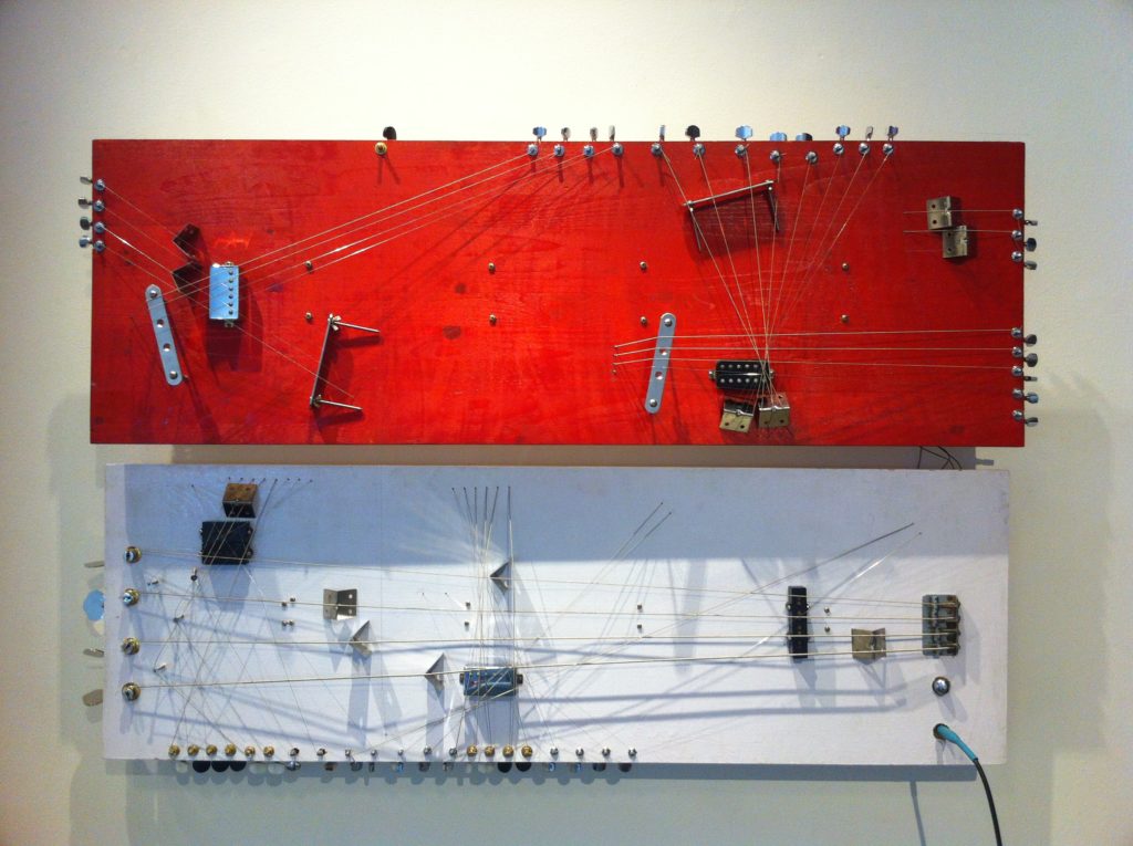 The Americans Have Colonized our Subconscious. 2014. Installation. Enamel paint, electric guitar, and bass pickup machine heads, bridge, electric guitar and bass strings on wood planks. 120cm x 39cm x 2cm (x2) Dimensions variable Photo: courtesy the artist