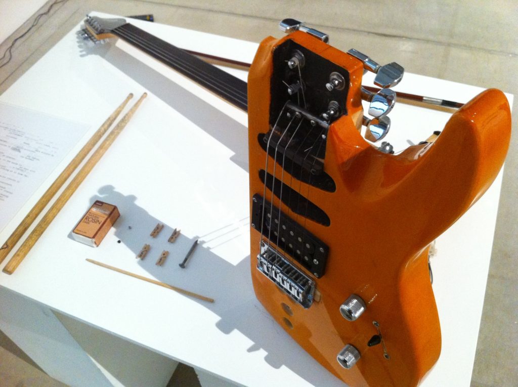 The Anti-guitar or How to Save the Electric Guitar from Brainless Rock Stars of the 21st Century. 2013. Installation Sawed off electric guitar, with additional tuning pegs and fixed bridge; violin bow; drum sticks; small wooden peg.  Dimensions variable Photo: courtesy the artist